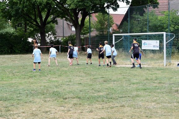 Es sind Kinder bei einem Fußballspiel zu sehen.